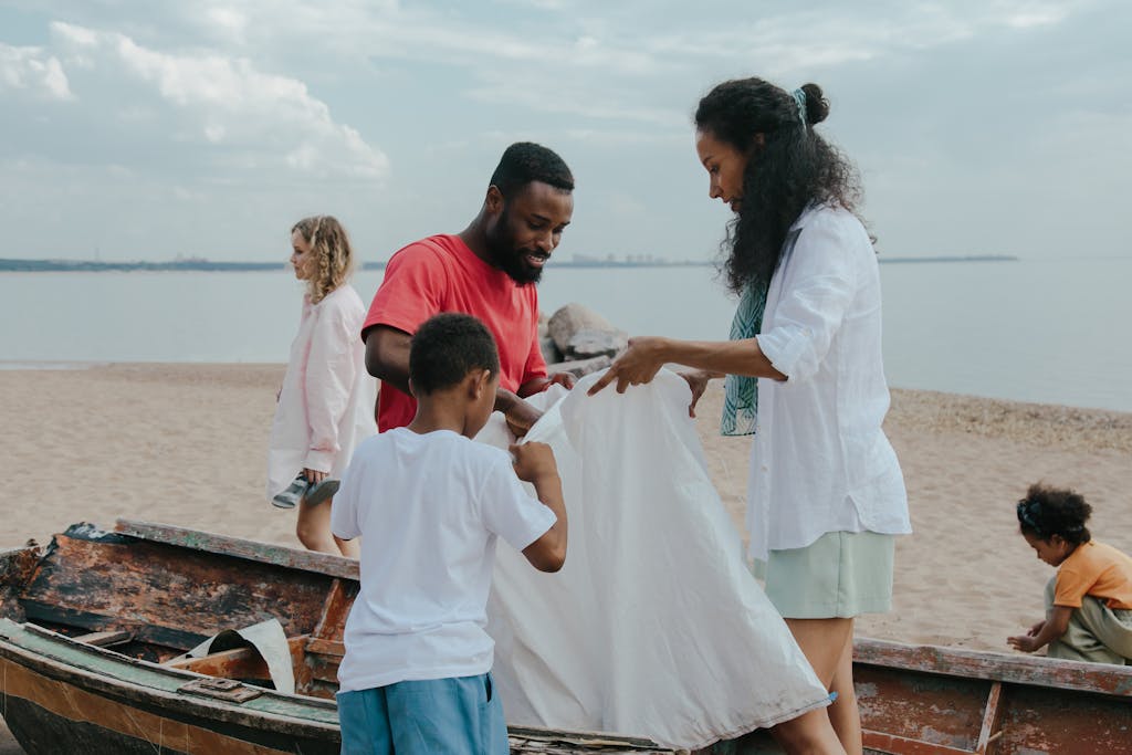 A diverse group gathers to clean the beach, promoting environmental conservation.