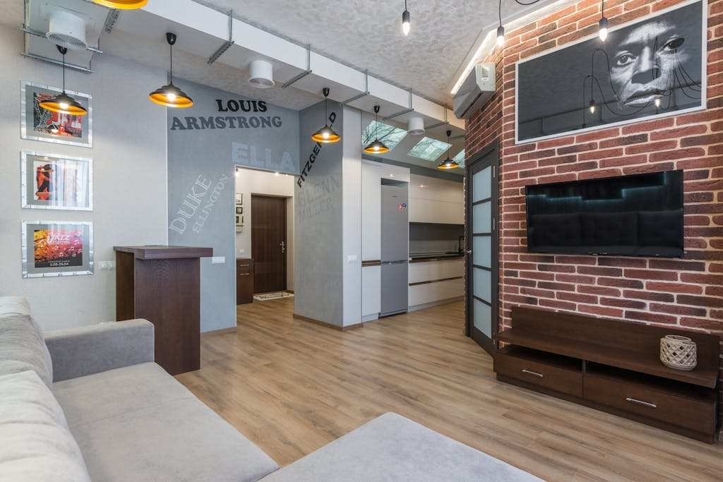 Stylish living room featuring a brick wall, jazz decor, and modern furnishings.